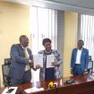 Eng. Ziria, Ongodia showing the signed MoUs as ERA's legal officer Counsel Harold Obiga looks on
